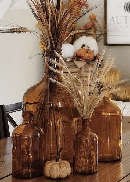 Thanksgiving Vase Centerpieces, Brown Jug Decor, Amber Bottle Fall Decor, Fall Birthday Party Centerpieces, Fall Decor With Amber Bottles, Decorating With Brown Glass Bottles, Amber Vase Decor, Brown Bottle Decor, Amber Vases Wedding Centerpieces