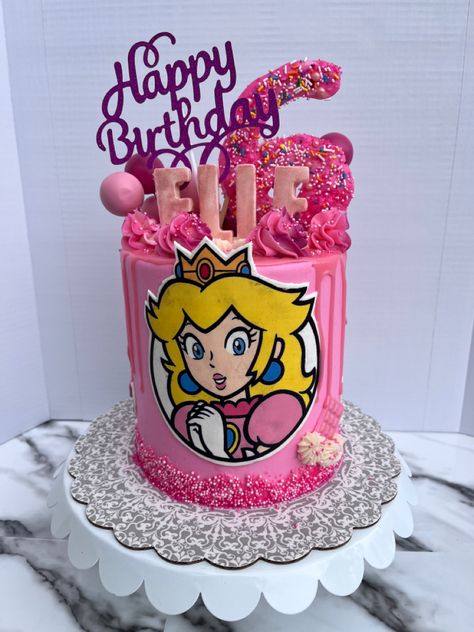 Princess Peach! A super fun birthday cake for a princess who turned 6! A three layer GF pink vanilla cake filled with milk chocolate and strawberries and topped with vanilla buttercream. And some chocolate toppers of course! Princess Peaches Cake, Princess Peach Cake Birthdays, Pastel Princesa Peach, Princess Peach Cake Topper, Princess Peach Cake, Double Barrel Cake, Princess Peach Party, Chocolate Toppers, Dora Cake