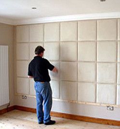 a man putting up padded wall tiles Padded Wall Panels, Fabric Wall Panels, Mom Bedroom, Panels Bedroom, Upholstered Wall Panels, Storage Solutions Bedroom, Bed Headboard Design, Upholstered Walls, Wall Paneling Diy