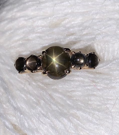 Black star sapphire ring in 14kt yellow gold Black Star Sapphire Ring, Star Sapphire Jewelry, Wedding Presentation, Valyrian Steel, Black Star Sapphire, Uncut Gems, Procreate Ideas, Star Sapphire Ring, Makeup Accesories