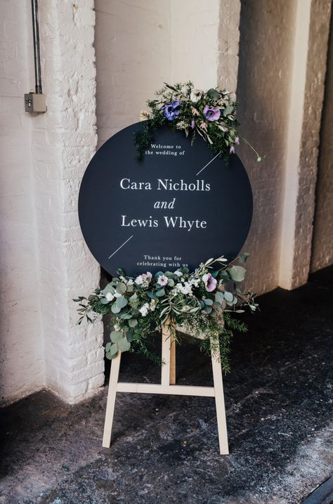 Flower Signage, Easel With Flowers, 100 Barrington, Welcome Easel, Morgan Davies, Round Welcome Sign, Feminine Flowers, Carpenter Photography, Flower Sign