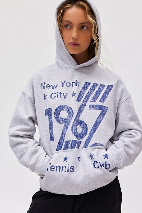 Staple hoodie sweatshirt in a slouchy, pullover style. Features a crew neckline, hood and drop shoulder balloon sleeves topped with 1967 Tennis Club graphics across the front for a sporty vibe. Only at Urban Outfitters. Features 1967 Tennis Club graphic hoodie sweatshirt Slouchy hoodie sweatshirt Crew neckline with hood and balloon sleeves 1967 Tennis Club graphics across the front Front kanga pocket Oversized fit Tunic length Easy pull-over style UO exclusive Content + Care 50% Cotton, 50% polyester Machine wash Imported Size + Fit Model in Grey is 5’9" and wearing size S/M Measurements taken from size S/M Chest: 48" Length: 27.5" | 1967 Tennis Club Graphic Hoodie Sweatshirt in Grey, Women's at Urban Outfitters Vintage Sports Sweatshirt, F1 Sweatshirt, Urban Outfitters Hoodie, Urban Outfitters Sweatshirt, Trendy Crewneck Sweatshirt, Tennis Sweatshirt, Trendy Crewneck, Fitted Tunic, Tennis Club