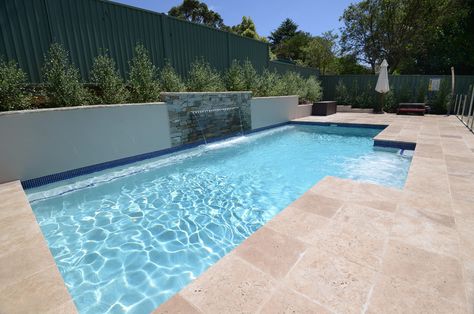 This geometric pool takes advantage of full sun and includes a magnificent sheer descent wall and a stunning retaining wall finished in tumbled stack stone. Pool Water Feature Wall, Tiled Garden, Mojo Homes, Lap Pools, Garden Board, Stacked Stones, Geometric Pool, Water Feature Wall, Planter Wall