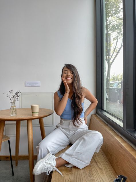 Sitting in a coffee shop wearing blue shirt and white pants Coffee Shop Date Outfit Summer, Coffeeshop Outfit Aesthetic, Coffee Shop Outfit Aesthetic Fall, Cute Coffee Date Outfits Fall, Grabbing Coffee Outfit, Coffee Shop Ootd Aesthetic, Coffee Shop Outfit Summer, Coffee Dates Outfits, Coffee Shop Date Outfit