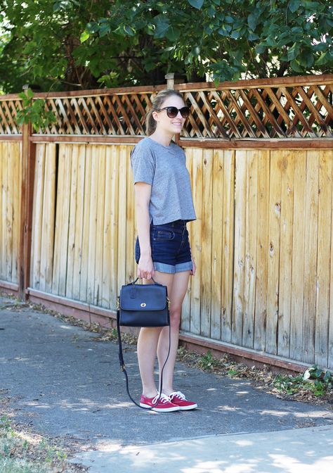 Grey cropped tee with high-rise denim shorts, red Keds, and navy vintage Coach bag Vintage Coach Court Bag Outfit, Coach Court Bag, Keds Outfits, Bi Fashion, Red Keds, Curated Wardrobe, Vintage Coach Bag, Keds Style, Early Fall Outfits