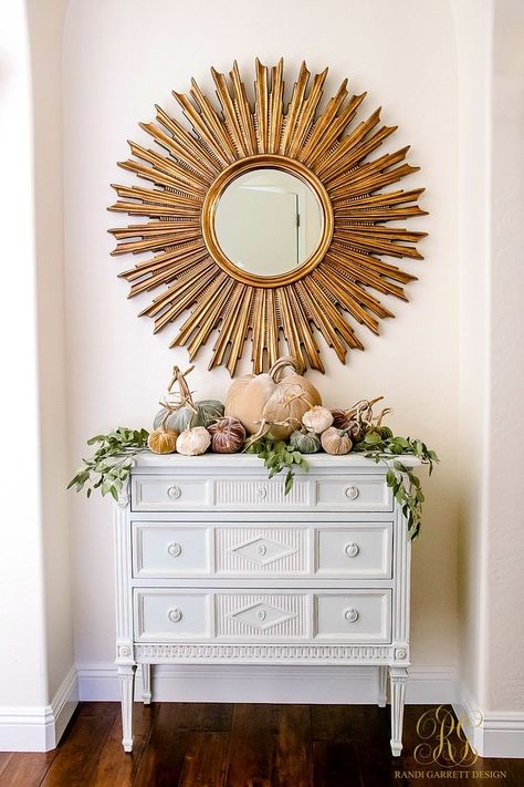 Velvet pumpkin vignette with eucalyptus leaves and a gold sunburst mirror on a white credenza. Fresh Ideas for Fall Home Tour - Elegant Fall Decor - Randi Garrett Design Elegant Fall Decor, Gold Sunburst Mirror, Credenza Decor, White Credenza, Staining Furniture, Fall Entryway, Fall Home Tour, Gold Sunburst, Traditional Interior Design