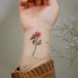 Tattoo uploaded by Justine Morrow | Rose hips tattoo by Stellatxttoo #stellatxttoo #selfharmscarcoveruptattoo #coveruptattoo #scarcoveruptattoo #scarcoverup #coverup #roses #flowers #floral #leaves #plant #nature | 925785 | Tattoodo Finger Tattoos For Women, Rose Tattoo On Hip, Wrist Tattoos Girls, Scar Cover Up, Tattoos To Cover Scars, Finger Tattoo For Women, Scar Tattoo, Small Wrist Tattoos, Up Tattoos