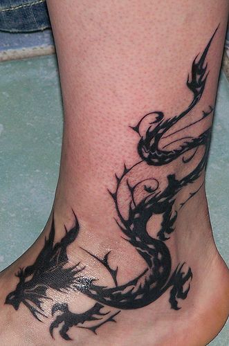 Ankle tattoos dragons | Tribal Tattoo Design: Black Dragon Tribal Tattoo: on Foot Dragon Ankle Tattoo, Dragon And Tiger Tattoo, Ankle Tattoo Men, Stammestattoo Designs, Traditional Heart Tattoos, Around Arm Tattoo, Tatuagem Masculina Pequena, Ankle Tattoo Designs, Waist Tattoos