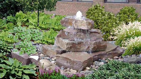 Build a stacked stone water feature: easy steps Stacked Stone Fountain Diy, Diy Rock Fountain Stacked Stones, Stacked Stone Water Fountain, Flagstone Fountain Diy, Small Stone Fountain, Backyard Waterfalls Diy, Diy Disappearing Water Fountain, Stacked Stone Waterfall, Stone Fountain Garden