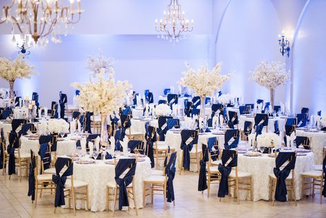 Navy blue, ivory with gold accents for a wedding reception at Villa Tuscana Reception Hall. Www.villatuscanaevents.com Navy Blue Gold And Silver Wedding, Navy Blue Champagne Wedding Receptions, Champagne Gold And Navy Blue Wedding, Navy Blue And Ivory Wedding Decorations, Royal Blue And Champagne Quinceanera, Navy Blue And Gold Wedding Reception, Champagne Gold And Blue Wedding, Ivory And Navy Blue Wedding, Navy Blue Gold White Wedding