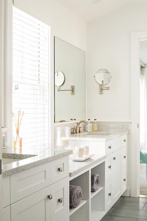 Beautifully designed white bathroom boasts his and her white washstands adorning polished nickel square knobs and speckled quartz countertops fitted with satin nickel faucets placed beneath frameless vanity mirrors mounted on either side of a window dressed in white blinds. Corner Bathroom, Contemporary Bathroom Designs, Bad Inspiration, Medicine Cabinets, Master Bath Remodel, White Vanity, Half Bathroom, Basement Bathroom, Upstairs Bathrooms