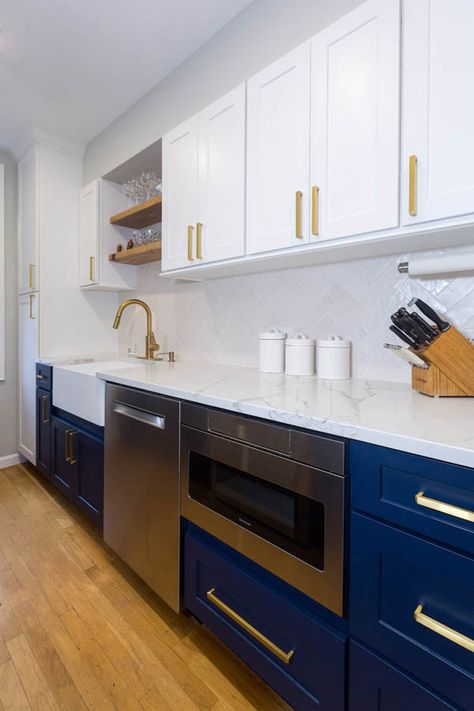 white kitchen with blue base cabinets, microwave cabinet next to stainless dishwasher and wood floating shelves above the sink White Galley Kitchens, Small Galley Kitchen Designs, White Galley Kitchen, Galley Kitchen Renovation, Stainless Dishwasher, Galley Kitchen Layout, White Kitchen Appliances, Microwave Cabinet, Galley Kitchen Design