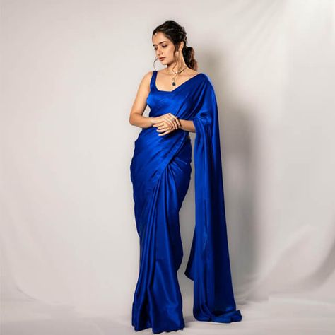 Ashika Ranganath dazzles in the trailer launch of Avatarapurusha 2 wearing a plain blue saree, setting the stage for a captivating narrative. Blue Satin Saree Look, Royal Blue Saree Look, Plain Saree Look, Electric Blue Saree, Royal Blue Indian Outfit, Blue Saree Look, Plain Satin Saree, Blue Indian Outfit, Dark Blue Saree