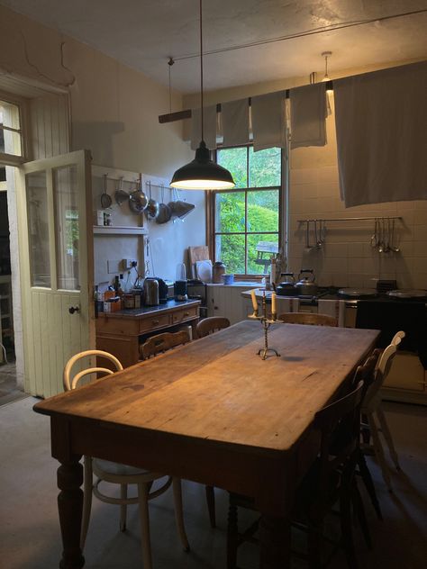 Farm kitchen dining room cottage core wooden table mismatch chairs candle larder aga cooker stove kettle vintage antique 1800s 19th century old houses linens white sheets laundry washing Antique Table Modern Chairs, Dining Room Cottage, 1800s Kitchen, Monkeys Paw, Stove Kettle, Lodge Kitchen, Limestone House, Vintage Kitchen Table, Aga Cooker