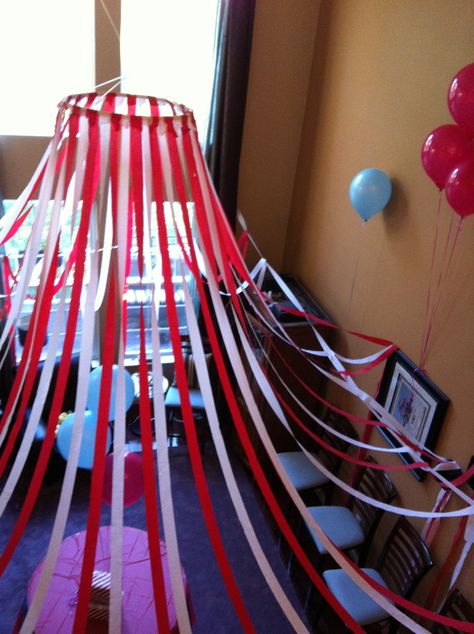 Circus tent -made with a small hula hoop (in center) and red and white crepe paper. Suspend from ceiling with fishing wire Creepy Circus Trunk Or Treat, Diy Halloween Circus Props, Easy Carnival Decorations Diy, Carnevil Halloween Party Decor, Scary Circus Decorations, Carnival Birthday Party Decorations Diy, Clown Halloween Party Ideas, Circus Halloween Party Decorations, Spooky Circus Decorations