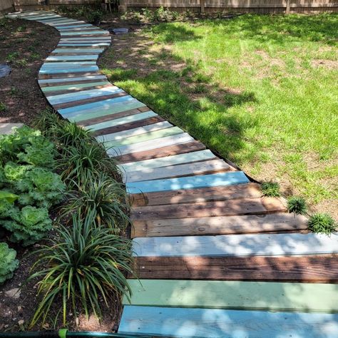 I created this path in my backyard from old 6' wood privacy fence pickets. Repurpose Deck Boards, Diy Pathway Ideas Walkways Pallet Wood, Creating Paths In Woods, Diy Boardwalk Path, Old Fence Wood Projects, Pallet Path, Backyard Boardwalk, Wood Pallet Walkway, Board Walk Garden Pathways