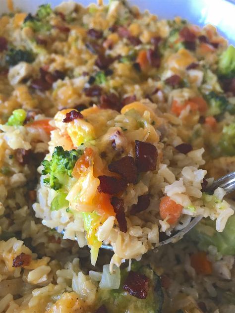 A close up shot of the broccoli casserole with a silver spoon being held over the dish. Broccoli Brown Rice Casserole, Healthy Broccoli Casserole, Brown Rice Casserole Recipes, Broccoli And Brown Rice, Broccoli Brown Rice, Broccoli Casserole Healthy, Cod Fillet Recipes, Roast Beef Sandwich Recipes, Casserole With Chicken