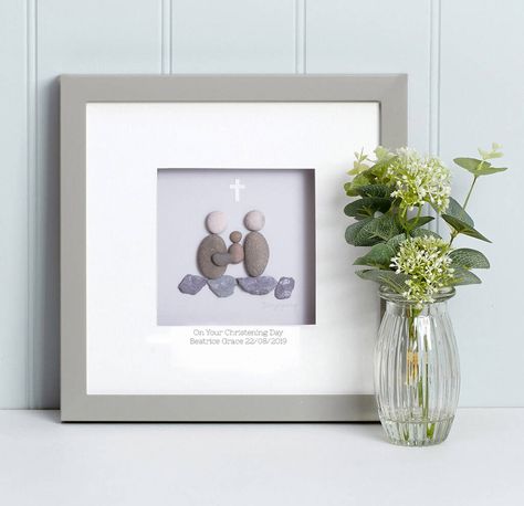 A stunning framed picture, handmade using natural pebbles and slate.Precision placed natural pebbles and slate have been cleverly combined to create a beautiful symbolic sentiment featuring two "Pebble People" and a baby in an embrace with a small white cross delicately placed above them. The simple words, displayed on a co-ordinating plaque beneath the artwork will display your message. Please change the wording or add personalisation of your choice. You could add names, dates, initials or a Pebble People, Handmade Baby Gifts, Pebble Pictures, Garden Artwork, Collage Art Mixed Media, Stone Pictures, Personalized Artwork, Christening Gifts, True Friends