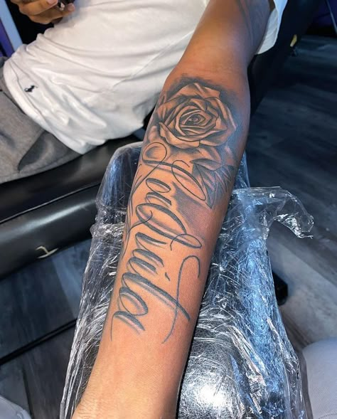 Mothers Keeper Tattoo For Men, Arm Tattoos With Names, Arm Tattoo Rose, Forearm Tattoos With Names, Mother Name Tattoo, Last Name Arm Tattoo, Tattoo Ideas For Men Mom, Tattoo Ideas For Men With Names, Family Members Tattoo Ideas