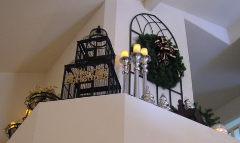 Birdcage, large iron piece, tall candles, wreath. Decorate a plant ledge for high tall foyer entryway. Planter Shelf Decor Ideas, Vaulted Ceiling Ledge Decorating Ideas, Plant Ledge Decorating Vaulted Ceilings, Candle Scounces Nect To Tv, Entryway Ledge, Ceiling Ledge Decor Ideas, High Shelf Decorating Ideas, Living Room Ledge Decor Vaulted Ceilings, Decorating Ledges