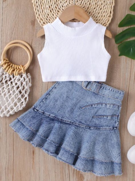 Sweet with a touch of sassy, our pleated denim skirt set is loved by little fashionistas. A classic white crop and pirouette-friendly skirt make the season extra stylish. Pair with a cowgirl hat and she'll be overflowing with cuteness! Soft blend fabric is lightweight and breathable, so she stays comfy and confident all day. Versatile pieces are easy to mix and match with her other faves for year-round cuteness.  Perfect for spring, casual outings, cowgirl adventures, playdates, photoshoots, and more Set includes white rib knit sleeveless top and light wash denim skirt with pleated details and matching belt  Available in sizes 3T-7Y for toddlers and girls