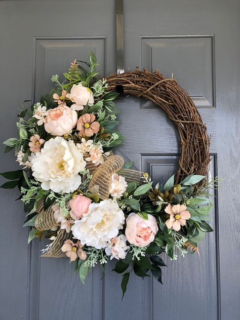 These are the best spring wreaths for your front door in 2023. These gorgeous wreath ideas include farmhouse style, grapevine wreaths, and more. Wreath With Peonies, Peony Wreaths For Front Door, Elegant Spring Wreaths, Early Spring Wreath Ideas, Easy Spring Wreaths To Make, French Country Wreath, Floral Wreaths For Front Door, Spring Wreath Ideas Diy, Spring And Summer Wreaths