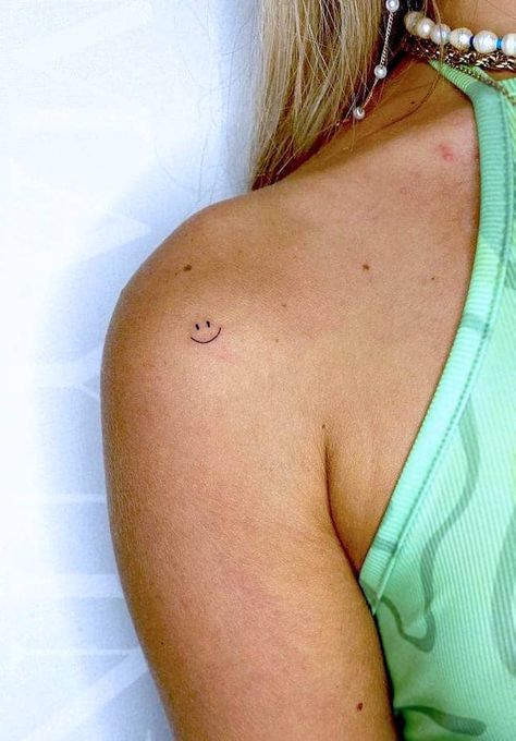 Tiny Tattoo On Shoulder, Dainty Smiley Face Tattoo, Tiny Smiley Tattoo, Tiny Front Shoulder Tattoo, Smiley Face Knee Tattoo, Happy Small Tattoos, Simple Smiley Face Tattoo, Small Tattoo Shoulder Women, Shoulder Tiny Tattoo