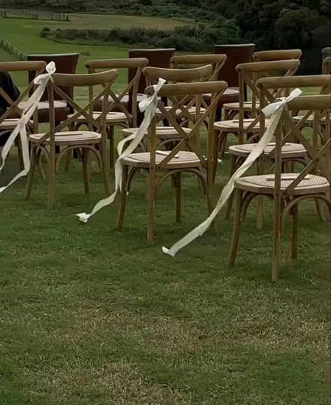 Alternative Wedding Aisle, White Chair Bows Wedding, White Garden Chairs Wedding Ceremony, Wedding Aisle No Flowers, Garden Wedding Chairs, Ribbon Aisle Markers, Chair Markers For Wedding, Wood Chairs Wedding Ceremony, Ribbon Aisle Decor