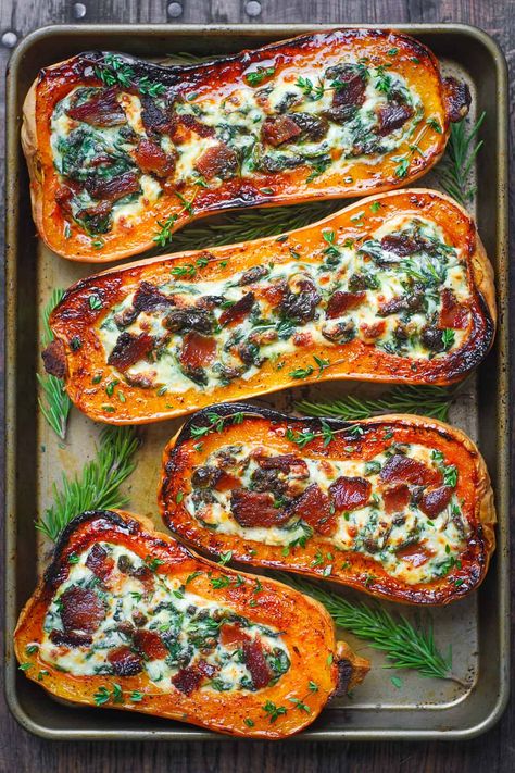 stuffed butternut squash with spinach, bacon, and cheese on a baking sheet Healthy Stuffed Butternut Squash, Chicken Stuffed Butternut Squash Recipes, Sunday Winter Dinner Ideas, Vegan Gluten Free Christmas Dinner, Squash Boats Stuffed, Stuffed Butternut Squash Recipes, Stuffed Pumpkin Recipes, Fall Sunday Dinner Ideas, Butternut Squash With Spinach