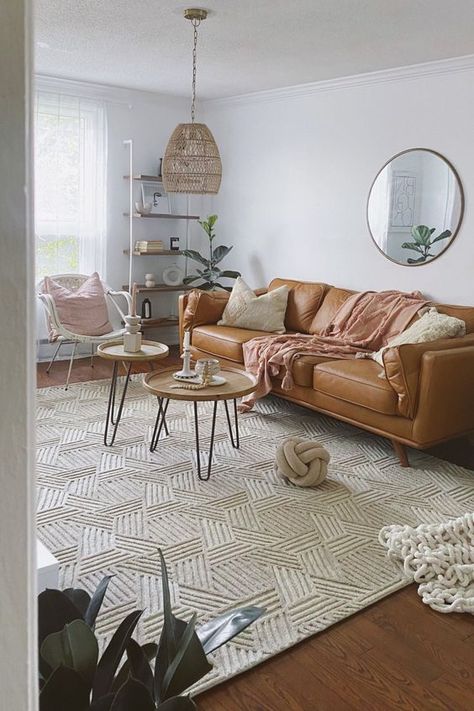 Picture of a boho living room with a tan leather sofa, coffee tables, a rattan chair, a shelving unit and a pendant lamp plus a cool big rug Tan Couch Living Room, Tan Couch, Tan Living Room, Leather Couches Living Room, Brown Couch Living Room, Modern Boho Living Room, Leather Sofa Living Room, Couch Living Room, Living Room Design Decor