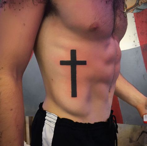 Black simple cross on ribs tattoo by Jenny Forth, Miami ... #crosstattoos #tattoosformen Cross Rib Tattoo Men, Cross On Ribs Tattoo, Cross Tattoo On Ribs, Simple Cross Tattoo For Men, Ribs Tattoo Men, Mens Cross Tattoo, Mens Rib Tattoo, Black Cross Tattoo, Rib Tattoo Men