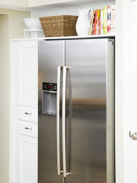 Appears to be built in fridg....what we want.  A base cabinet topped with an upper cabinet makes a column of useful storage. One large shelf spanning the length of the niche creates a useful space for storing cookbooks and large servingware. The result is a boost of storage real estate, as well as the look of a pricey built-in refrigerator for a lot less. Space Above Fridge, Above Refrigerator, Top Of Fridge, Above Fridge, Above The Fridge, Refrigerator Ideas, Kitchen Space Savers, Refrigerator Wall, Outdoor Kitchen Appliances