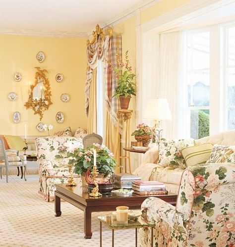 Buatta, a great admirer of decorator Nancy Lancaster's, painted the walls her favorite yellow. The gilt sconce is Chippendale. Regency gilt torchère, used as plant stand, H. M. Luther Antiques. Low table from Yale R. Burge. Lee Jofa floral upholstery fabric. Stark carpet. Mario Buatta, English Country Decor, French Country Living Room, Morning Room, English Decor, English Country Style, Yellow Living Room, Lee Jofa, Yellow Walls