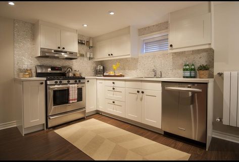 And with a backsplash like that, this kitchen has an extra dose of style, taking it from modern to glam in a snap. Basement Suite Ideas, Basement Rental, Easy Basement Ceiling, Contemporary Basement, Basement Kitchenette, Basement Reno, Diy Basement, Basement Kitchen, Apartment Makeover