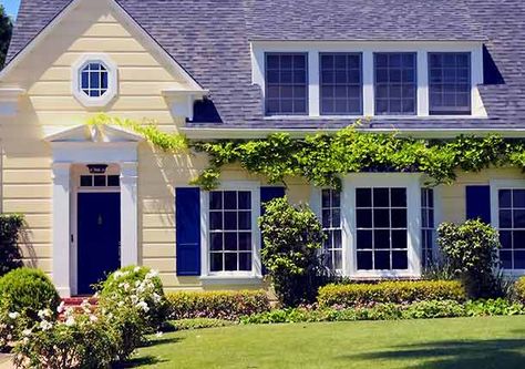 Pale yellow cottage-style home with blue door and shutters and white trim Yellow House Exterior, Exterior Paint Combinations, Shutter Colors, Best Exterior Paint, House Paint Color Combination, Color Combinations Paint, House Shutters, Yellow Cottage, Blue Shutters