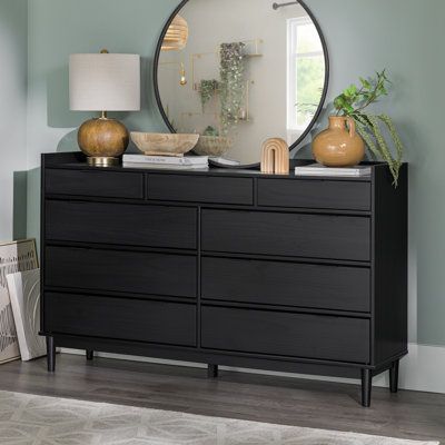 This 9-drawer double dresser brings a clean-lined style to your bedroom. It's made from solid pine and engineered wood, and it shows off a streamlined silhouette with a finish that highlights its natural wood grain (knots and all). Nine drawers with various sizes give you plenty of room for organizing your clothes, with space for everything from socks to sweaters to denim. They're accented with silver metal hardware, and safety stops on the drawers keep fingers from getting pinched. A wall ancho Black Dresser Bedroom, Tan Bedroom, Accent Drawer, Black Dresser, Mid Century Modern Aesthetic, Matching Nightstands, Solid Wood Dresser, 9 Drawer Dresser, Bedroom Furniture Dresser