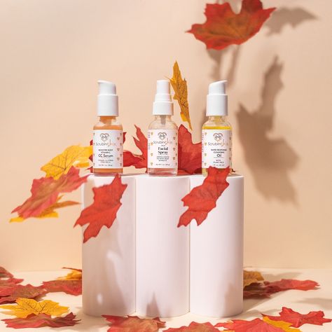 Skincare for nurses on white prop with cream background and maple leaves falling. For scub in skin photography and styled by aesthetic socials media Fall Themed Product Photography, Autumn Skincare Aesthetic, Fall Skincare Photography, Thanksgiving Skincare Posts, Fall Product Shoot, Fall Product Photoshoot, Autumn Product Photography, Halloween Product Photography, Fall Product Photography