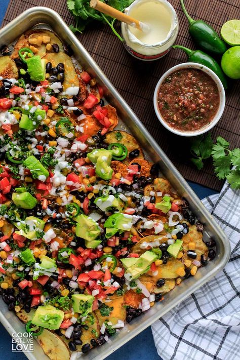 Sliced baked potato rounds replace the ordinary tortilla chips in this veggie loaded potato nacho recipe. These vegetarian Irish nachos with black beans, corn, jalapenos and cheese are perfect for a dinner meal or a party snack! Easy to make vegetarian nachos will be a hit no matter when you serve them up. Vegetarian Loaded Potato, Nacho Baked Veg With Crispy Black Beans, Veggie Loaded Baked Potato, Vegetarian Nachos Recipe Easy, Potato Nachos Baked, Healthy Potato Nachos, Sliced Baked Potato, Veggie Nachos Recipe, Potato Nachos Vegan