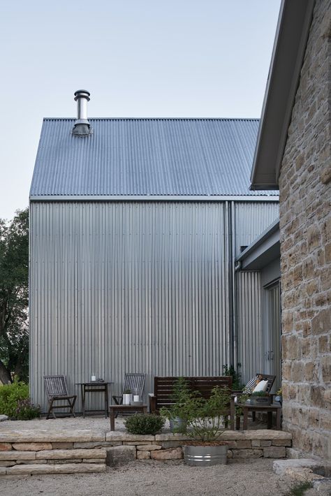 Photo 13 of 17 in A Limestone Cottage in Kansas Is Reborn With a Corrugated Steel Addition - Dwell Galvalume Siding, Limestone Cottage, Outdoor Stone Patio, Corrugated Metal Siding, Corrugated Steel, Gable House, Steel Cladding, Steel Siding, Modern Outdoor Spaces