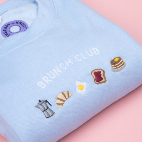 "This super cute Brunch Club Crewneck Sweatshirt is the perfect way to express yourself while still stayin' cozy! The super soft fabric and lovely colors make it a warm addition to any wardrobe. \"However you brunch, this Crewneck has you covered.\"   This crewneck sweatshirt has a soft feel lining making it super cosy. Please use the size guide on the last slide to determine which size to order. PLEASE DOUBLE CHECK YOUR SIZE BEFORE PURCHASING.  Colors: Blue   Free UK postage! Due to the made to order nature of this item, this item ships within 3-7 days from the purchase date. Delivery within UK takes 2-3 days.   Do drop me a message if you have any questions 📩" Cheap Crew Neck Tops For Brunch, Crew Neck Sweatshirt Fun, Designer Crew Neck Shirt, Cute Uk Sweatshirts, Cheap Crew Neck Shirt With Embroidered Graphics, Trending Crewneck, Sweatshirt And Shirt Outfit, Trendy Sweatshirts, Aesthetic Crewneck