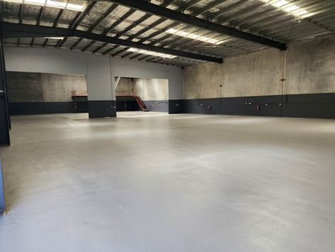 Do you ever wonder why the floors in warehouses, grocery stores, or gyms look so shiny and sturdy? That’s because they have epoxy flooring. In this article, we will explore the use of epoxy flooring in various industrial workspaces, focusing on warehouse applications. Warehouse epoxy flooring is a specialized flooring system where a mixture of […] The post Industrial Warehouse Epoxy Flooring￼ appeared first on Epoxy Flooring Brisbane | Floor Specialist | Queensland. Industrial Floor, Industrial Concrete Floor, Concrete Gym Floor, Industrial Flooring Concrete, Cleaning Concrete Floors, Metallic Epoxy Floor Basement, Warehouse Gym, Industrial Workspace, Epoxy Floor Commercial