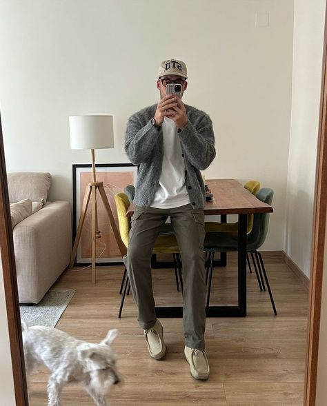 stylish man taking a selfie, wearing a baseball cap, grey cardigan, white t-shirt, dark pants, and wallabee boots Mens Grey Cardigan Outfit, Beige Flannel Outfits Men, How To Style Grey Cardigan, Men Cardigan Outfit Aesthetic, Seattle Outfits Winter Rainy Days, Grandpa Sweater Outfit Men, Men’s Cardigan Sweater Outfit, Cardigan Layering Outfit, Men’s Cardigan Outfit