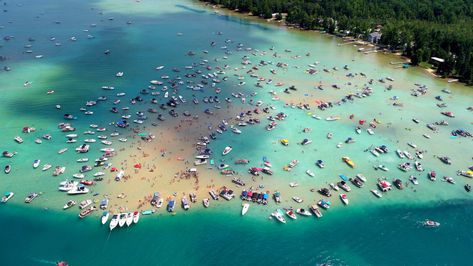 Colorful boats are anchored around the famous Torch Lake sandbar Torch Lake Michigan Things To Do, Torch Lake Michigan, Usa Vacations, Mackinaw Island, Travel Michigan, Beach Clouds, Boat Days, Michigan Adventures, Torch Lake