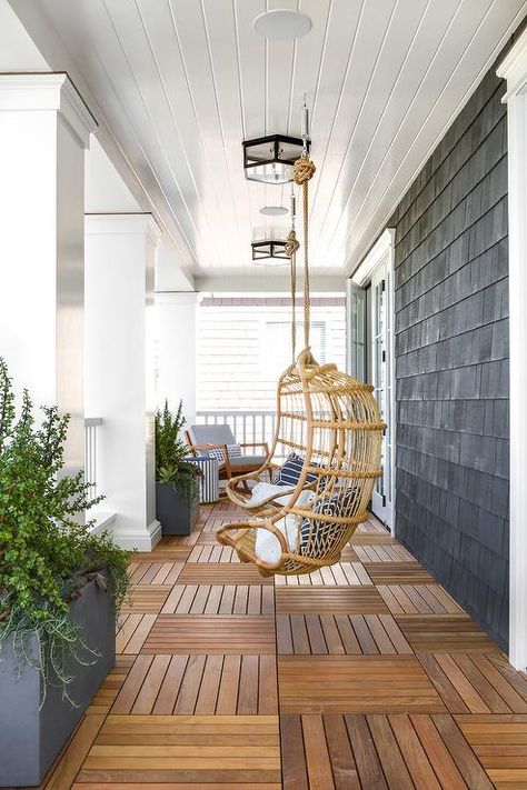 Rattan chairs hang from a white shiplap porch ceiling over teak floor tiles lit by glass and oil rubbed bronze flush mounts. Home Bunch, Home Improvement Loans, Front Patio, Diy Outdoor Decor, House With Porch, Porch Design, Interior Modern, Modern Coastal, Diy Patio