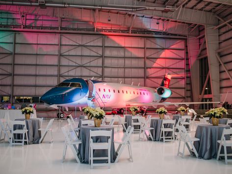 An Air Hangar Holiday Party Airplane Hanger Wedding, Airplane Hangar Wedding, Hangar Wedding, Airplane Hangar, Holiday Salads, Airplane Decor, Festive Cocktails, Food Stations, 50th Party