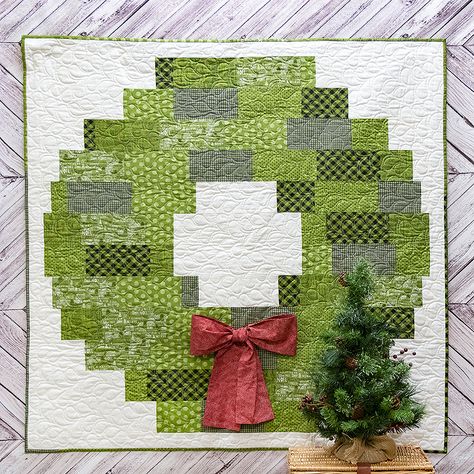 Deck the halls with this festive Christmas Wreath wallhanging. Quilt Kits For Sale, Christmas Quilting Projects, Christmas Quilt Blocks, Quilted Wall Hanging, Christmas Quilt Patterns, Quilt Care, Christmas Wall Hangings, Holiday Quilts, Quilt Festival