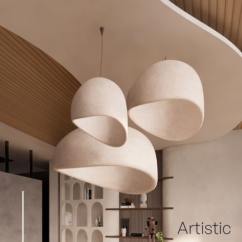 This elegant and modern lighting design features a cluster of three sculptural pendant lights, gracefully suspended from the ceiling. Their organic, asymmetrical shapes create a sense of fluidity and movement, blending seamlessly with the contemporary interior. The warm, neutral tones of the lampshades complement the natural wooden elements of the ceiling and wall panels, creating a harmonious and inviting atmosphere. The backdrop showcases open shelving with curated decor pieces, adding a to... Asymmetrical Shapes, Cluster Pendant Lighting, Curated Decor, Modern Lighting Design, Stylish Interior, Decor Pieces, The Ceiling, Wall Panels, Neutral Tones