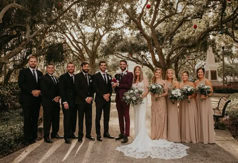 Bridal Party Portrait | Bridesmaids in Neutral Taupe Tan and Groomsmen Black with Burgundy Groom's Suit Burgundy Grooms Suit, Groom Suit Burgundy Wedding Colors, Burgundy And Taupe Wedding, Burgundy Groom Suit Wedding Inspiration, Wedding Party Black Suits, Maroon Groom Suit Wedding Inspiration, Burgundy And Tan Wedding Party, Burgundy Groom Suit And Groomsmen, Black And Tan Wedding Colors