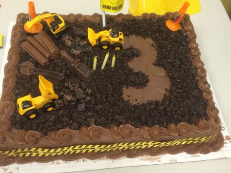 Construction theme Birthday cake.Semi-home made. Used a store bought Costco cake. Crumbled and grinded chocolate Oreos. Mini construction vehicles purchased at Toys R Us. Added some pieces from a favor bag purchased at Party City. Chocolate tools were a find at CVS and some Kit Kats. Construction ribbon came with gift wrap purchased on Amazon. To make the 3-cut out a 3 on wax paper and laid cookie down and removed the wax paper. Took off wax paper after I got it to the party location. #construct Costco Construction Cake, Construction Birthday Party Cakes, Construction Party Cakes, Birthday Cake Kids Boys, Costco Cake, Construction Birthday Cake, Truck Birthday Cakes, Small Birthday Parties, Construction Theme Birthday Party