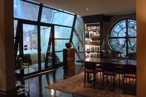 The building’s exterior wall clock makes a dramatic focal point in the dining room of the penthouse. "Built-in seating under the clock added a softness to the space," says Graves. "Modern mixed with traditional artwork pieces were handpicked for the walls, and the built-in bookcases were filled with art books and mementos." Modern Mixed With Traditional, Barbara Kean, Grand Budapest, Seth Meyers, Built In Seating, Dressing Rooms, Traditional Artwork, Woody Allen, Focal Points